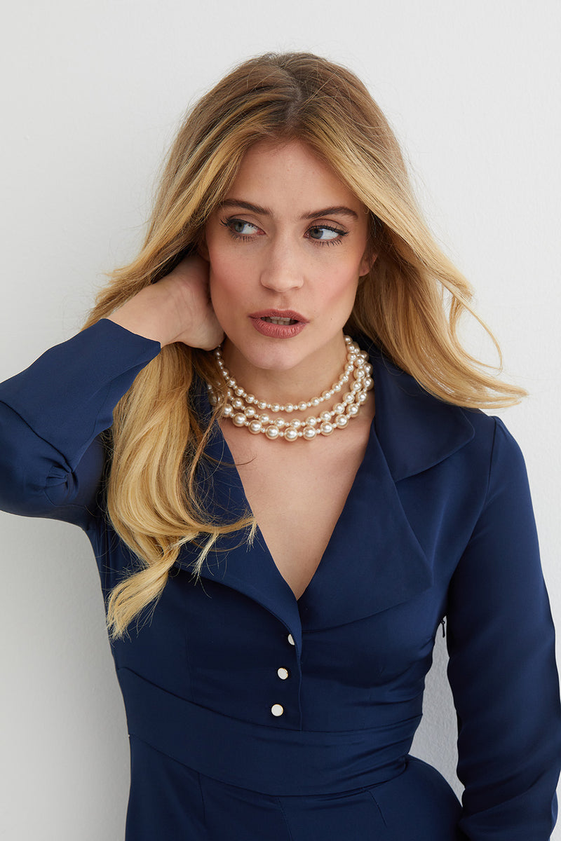 Pearl triple choker statement necklace worn by a model in a blue jumpsuit