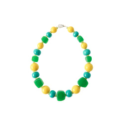 Green yellow blue statement necklace worn by a model in a 